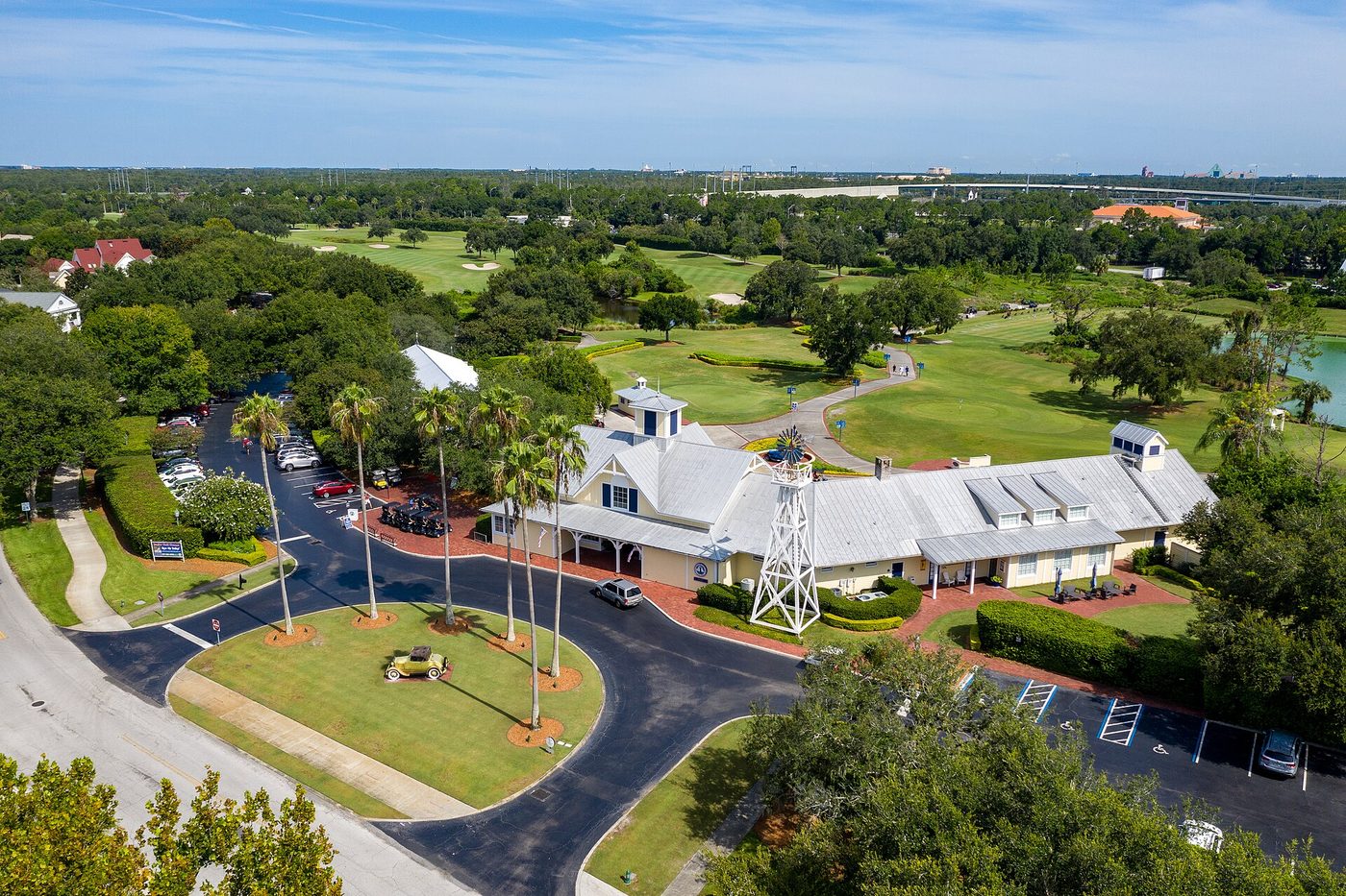 The white clubhouse and palm-lined drive at Celebration Golf Club in the planned town of Celebration, Florida