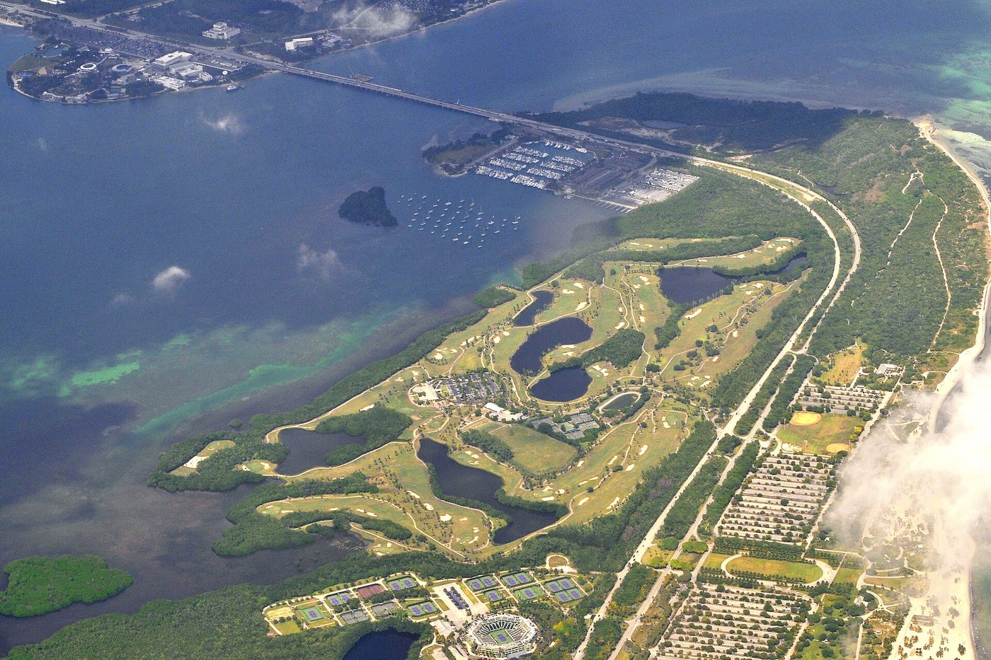 Aerial view of Crandon Golf's lakes and mangrove-lined fairways on Key Biscayne beside Biscayne Bay