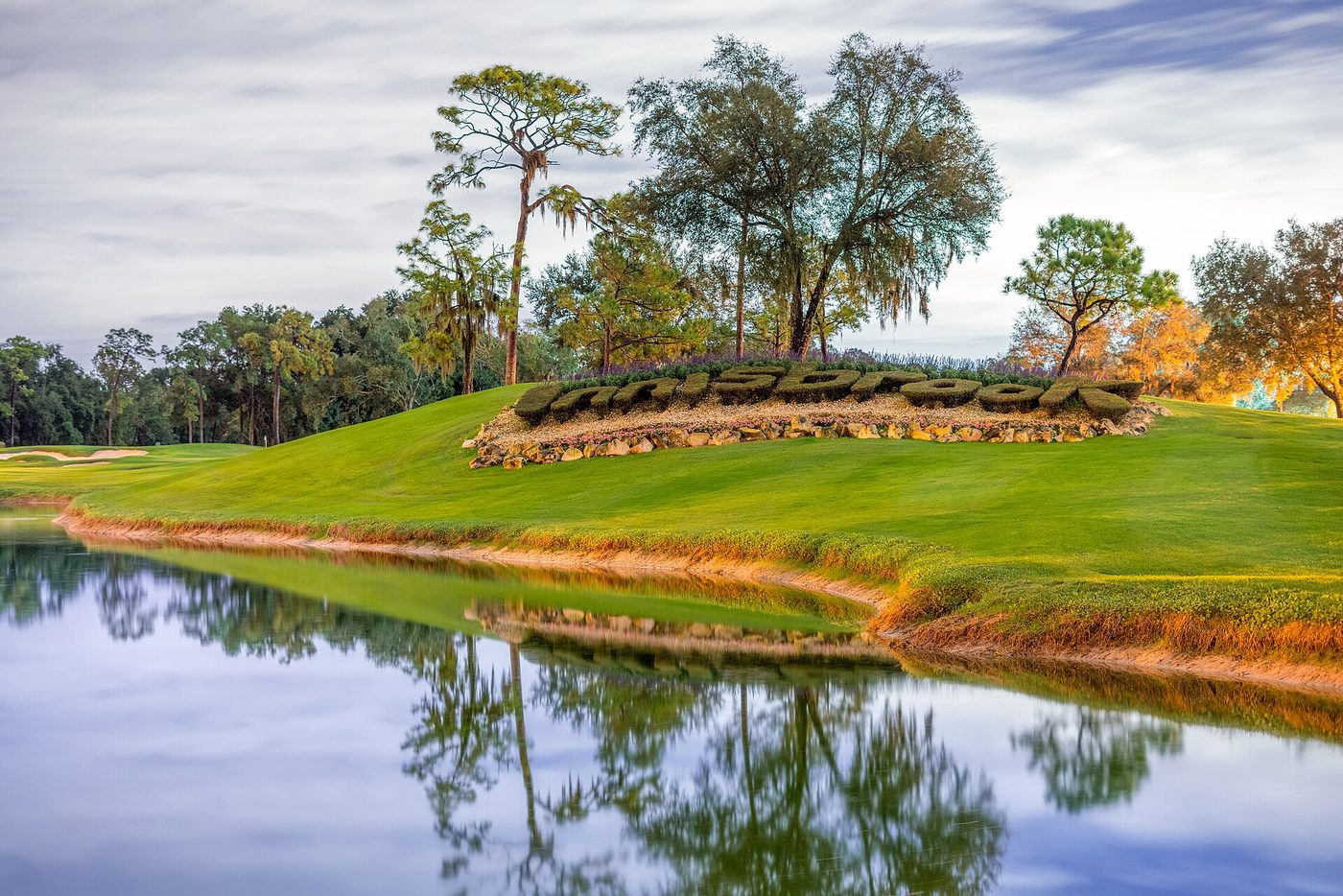 The Innisbrook sign on a mound above a pond at the resort in Palm Harbor, Florida