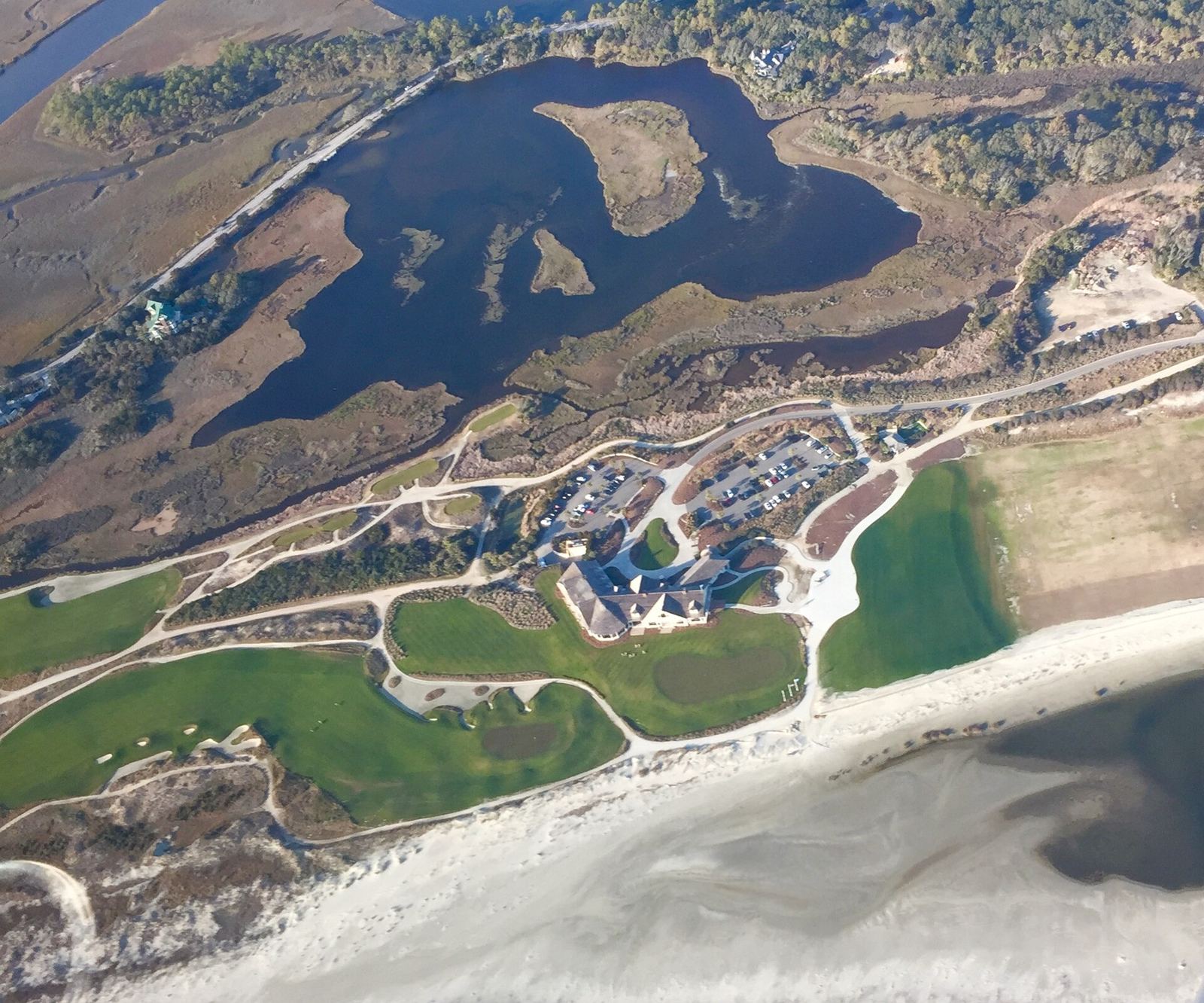 Aerial view of the Ocean Course clubhouse and holes along the beach at Kiawah Island, the top-ranked of the best golf courses in South Carolina