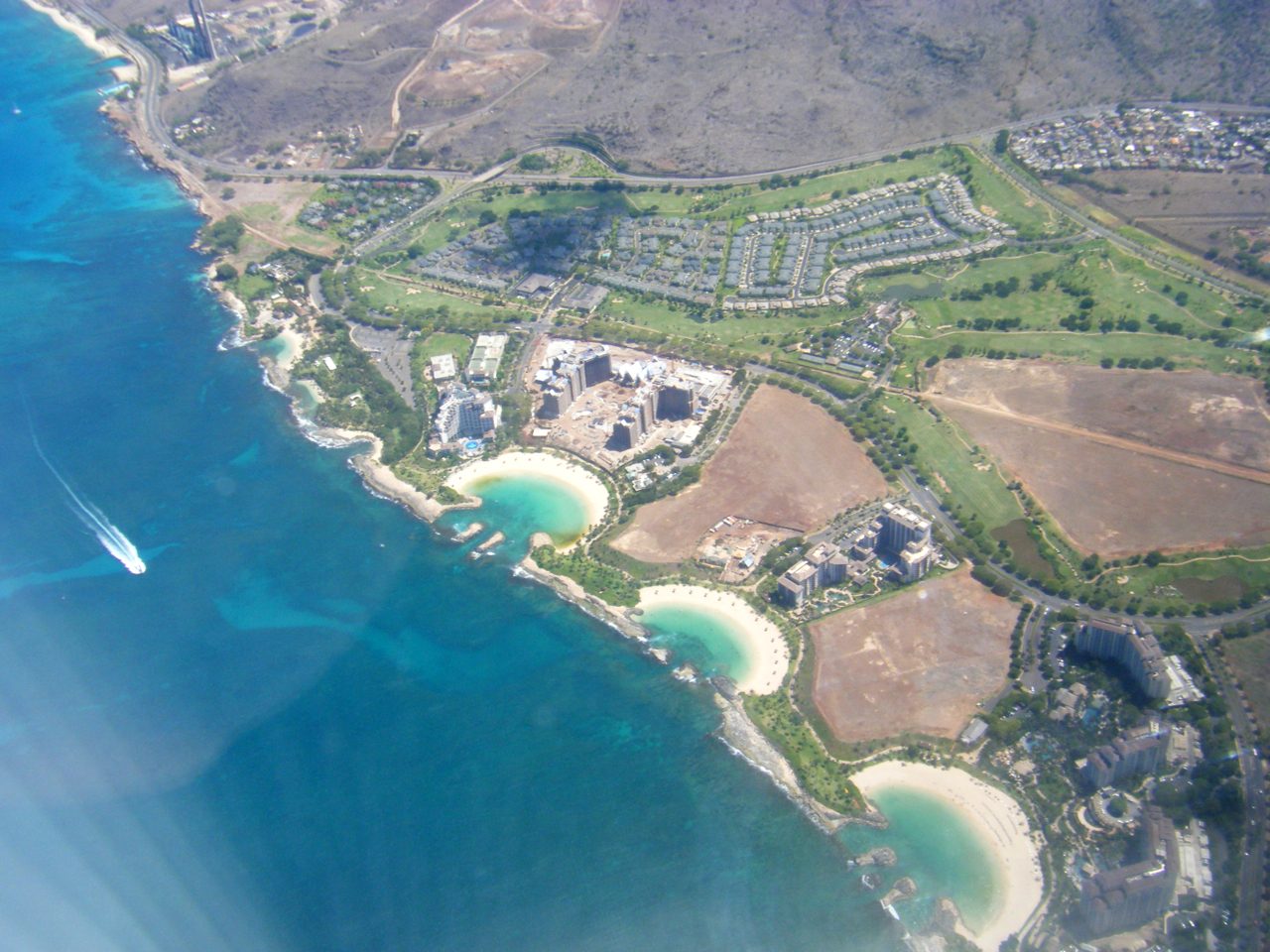Aerial view of the Ko Olina lagoons and resort on Oahu's west coast with the golf course inland