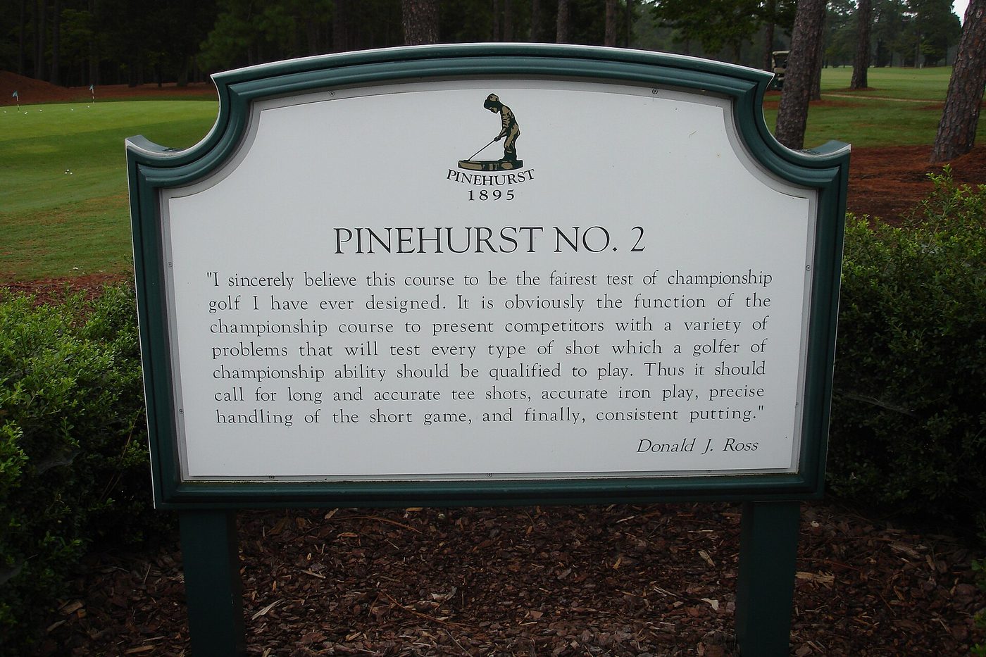 The Pinehurst No. 2 sign by the first tee, carrying a quotation from Donald Ross about the course