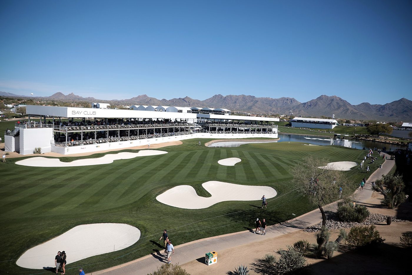 Hospitality stands and bunkers on the TPC Scottsdale Stadium Course during the WM Phoenix Open, with the McDowell Mountains behind