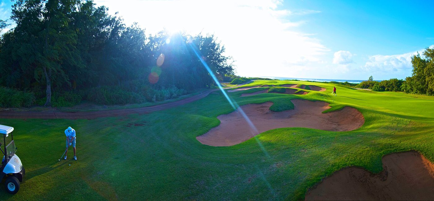 Bunkers guarding a green at Turtle Bay on Oahu's North Shore with the ocean visible behind