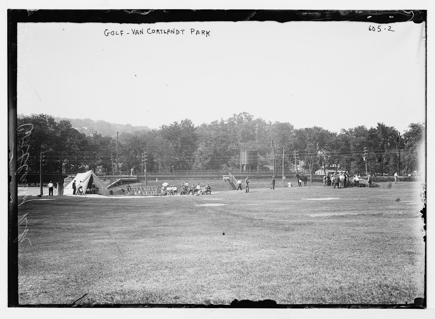 Golfers and spectators on the course at Van Cortlandt Park in the Bronx in an early twentieth-century glass-plate photograph