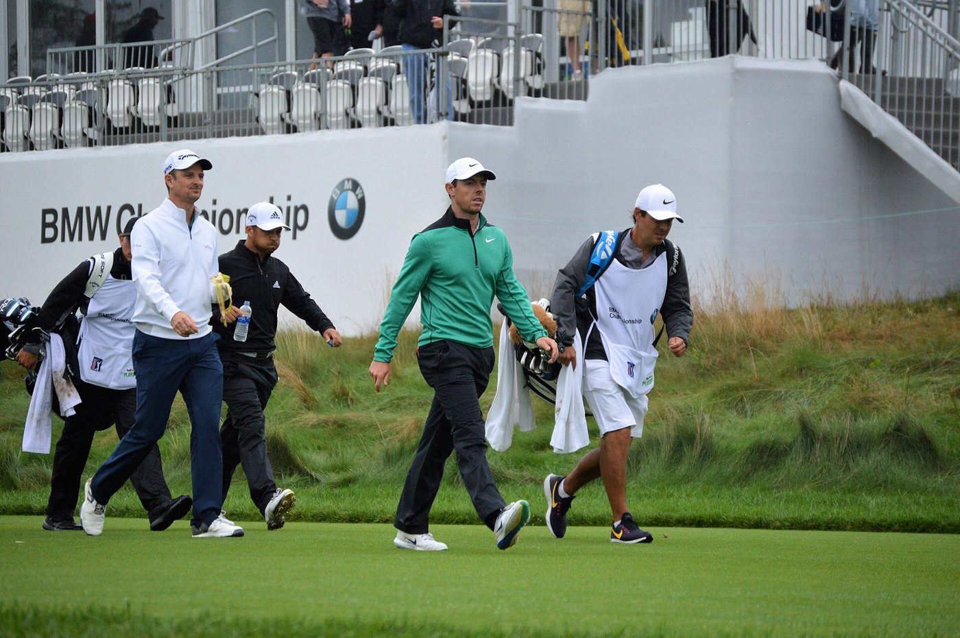 Rory McIlroy and his group walking up to a green in front of grandstands at Aronimink Golf Club during the 2018 BMW Championship