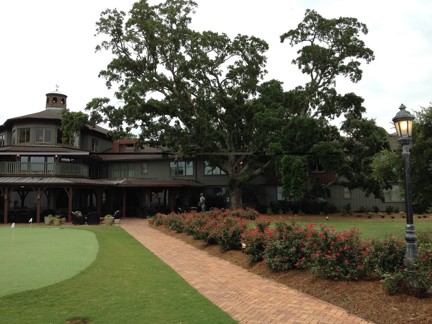 The Grand Hotel at Point Clear on Mobile Bay, with a putting green and a brick path in front of the hotel