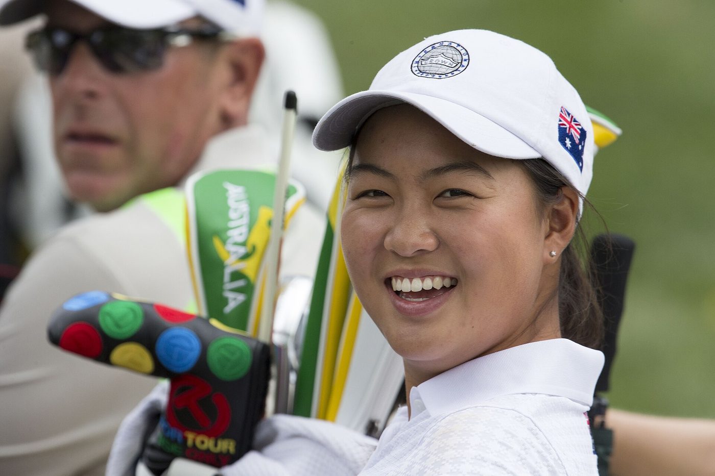 Australian golfer Minjee Lee smiling beside her golf bag at the 2014 LPGA International Crown