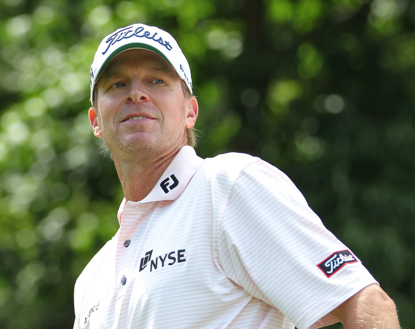 Steve Stricker in a white cap and striped shirt during a practice round at the 2011 U.S. Open